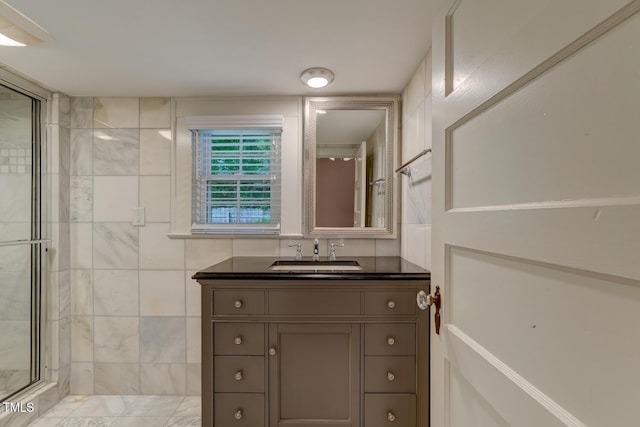 full bathroom with a stall shower and vanity