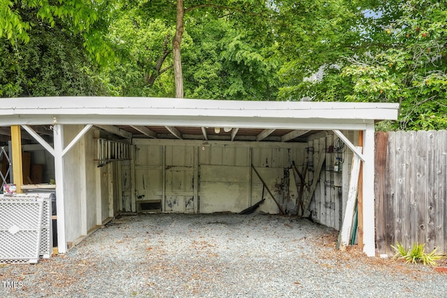 view of parking / parking lot featuring fence