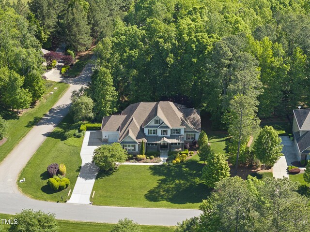 drone / aerial view with a wooded view