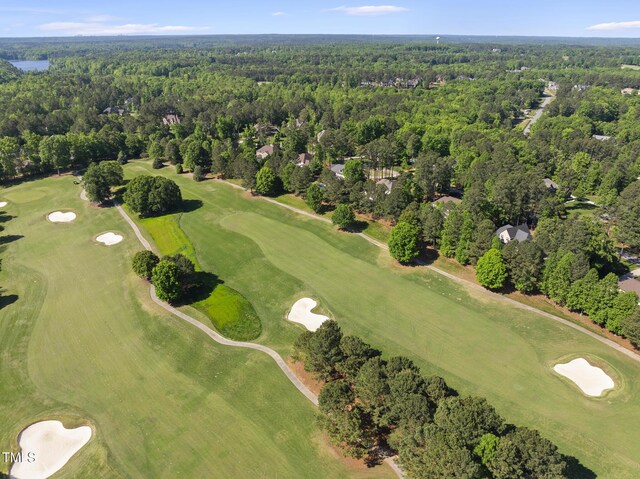birds eye view of property featuring golf course view and a forest view