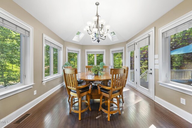 sunroom / solarium featuring a healthy amount of sunlight, a notable chandelier, french doors, and visible vents