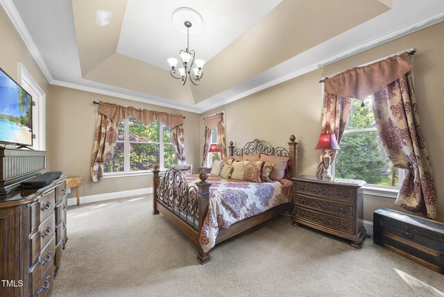 carpeted bedroom with crown molding, baseboards, a chandelier, and a raised ceiling
