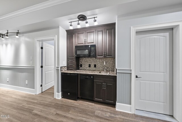 kitchen with dark brown cabinets, track lighting, black appliances, and light wood-style floors