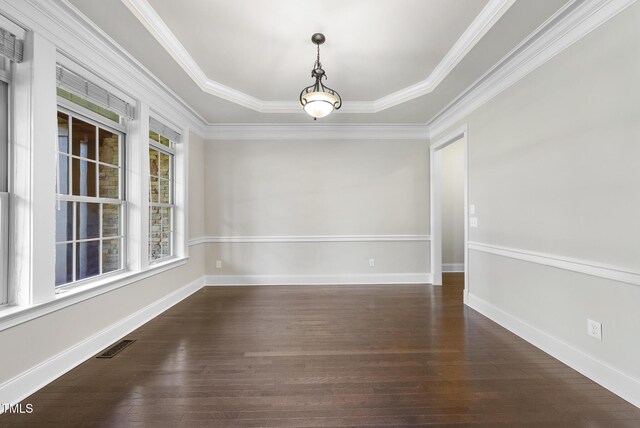 spare room with crown molding, baseboards, visible vents, and dark wood-type flooring