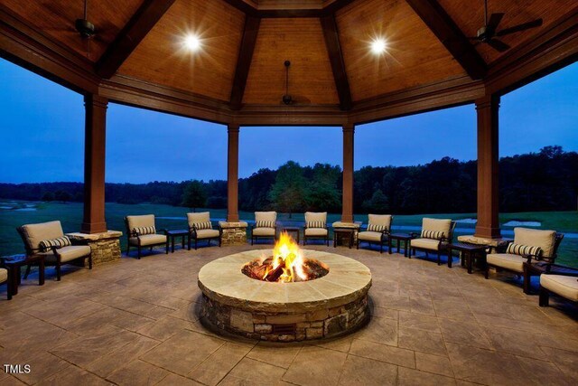 view of patio / terrace with a ceiling fan, a gazebo, and an outdoor fire pit