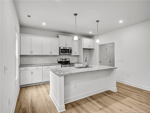 114 Kingwood Dr, Lillington, NC 27546 - kitchen featuring stainless steel appliances, visible vents, a sink, and light wood-style flooring