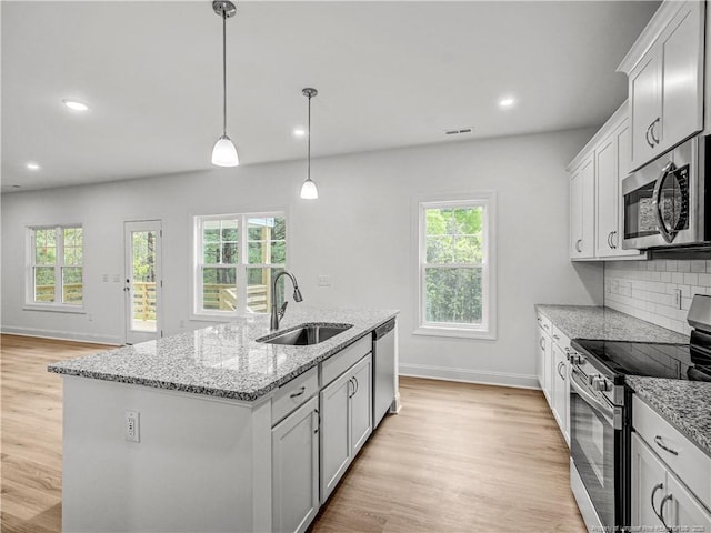 114 Kingwood Dr, Lillington, NC 27546 - kitchen featuring stainless steel appliances, a wealth of natural light, baseboards, and a sink