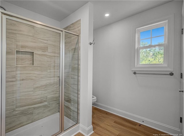 114 Kingwood Dr, Lillington, NC 27546 - bathroom with recessed lighting, toilet, wood finished floors, a stall shower, and baseboards