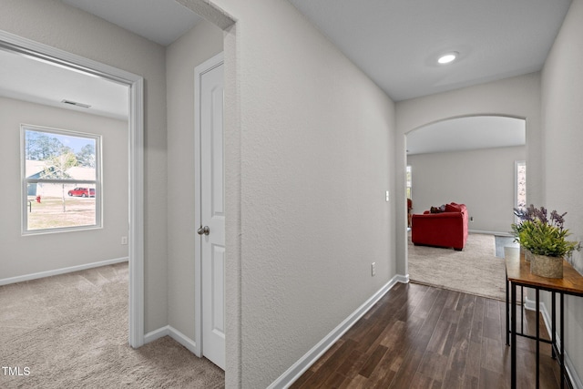 2040 Alderman Way, Creedmoor, NC 27522 - hallway with arched walkways, baseboards, and dark wood-type flooring