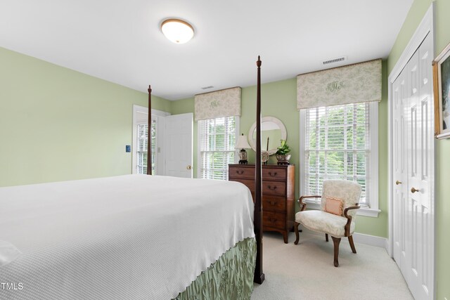 bedroom featuring carpet, multiple windows, and baseboards