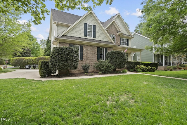 view of front of home with brick siding and a front lawn