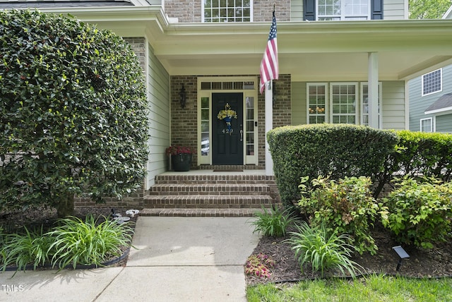 view of exterior entry featuring brick siding