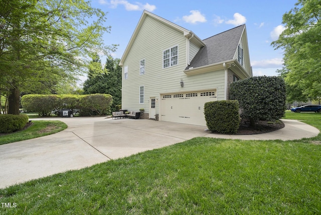view of side of home featuring concrete driveway, a lawn, outdoor lounge area, an attached garage, and roof with shingles