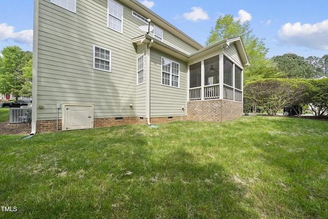 back of property featuring a lawn, a sunroom, a ceiling fan, and crawl space
