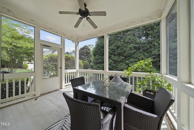 sunroom / solarium with a wealth of natural light, outdoor dining area, and ceiling fan