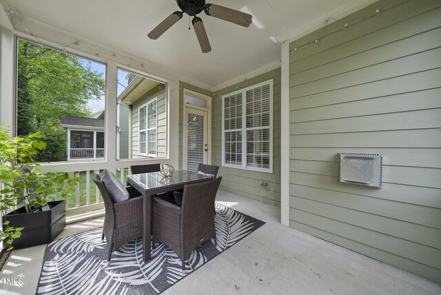 exterior space with outdoor dining area, a sunroom, and ceiling fan