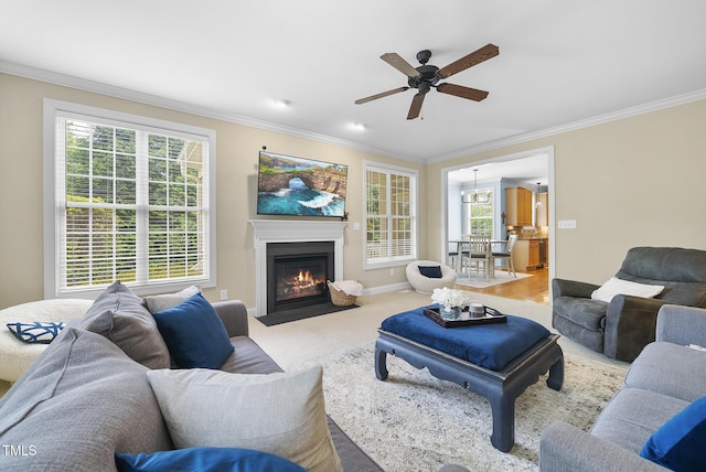 living room featuring a wealth of natural light, crown molding, and ceiling fan