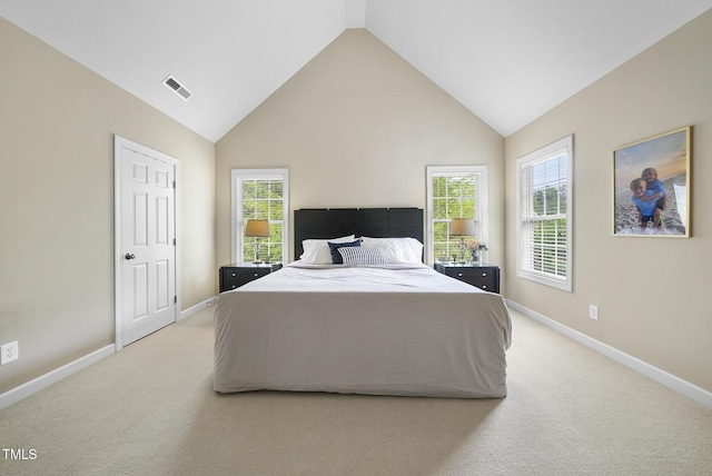 bedroom with light colored carpet, baseboards, multiple windows, and visible vents