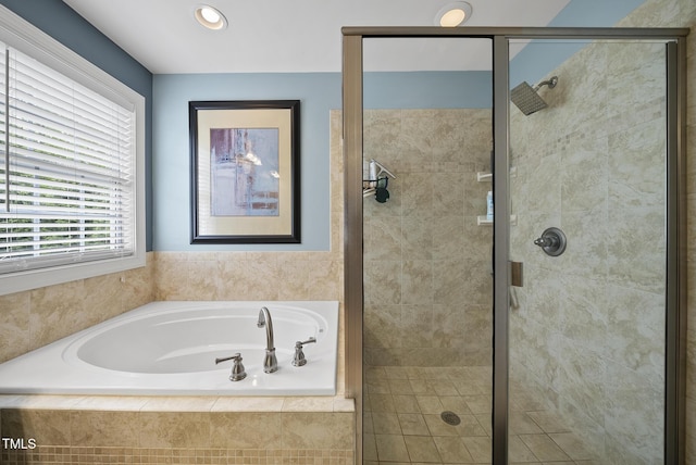 full bathroom with a bath and a shower stall