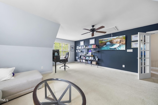 interior space with attic access, baseboards, carpet, and ceiling fan