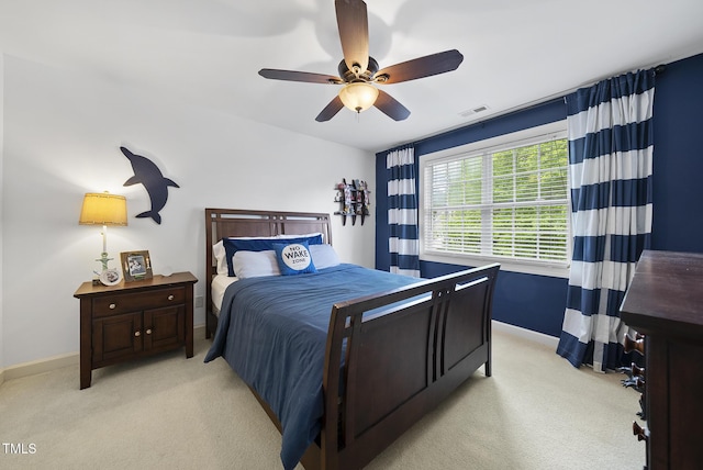 bedroom featuring light colored carpet, baseboards, a ceiling fan, and visible vents