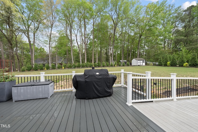 6024 Lunenburg Dr, Raleigh, NC 27603 - deck with grilling area, a storage unit, a yard, and an outbuilding