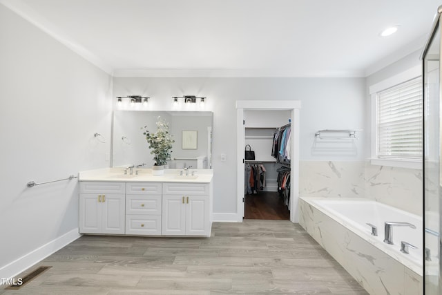 6024 Lunenburg Dr, Raleigh, NC 27603 - bathroom with a bath, visible vents, a sink, and double vanity