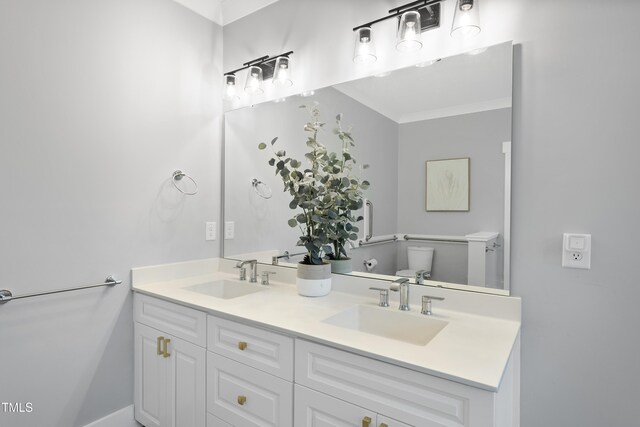 6024 Lunenburg Dr, Raleigh, NC 27603 - full bath featuring crown molding, double vanity, toilet, and a sink