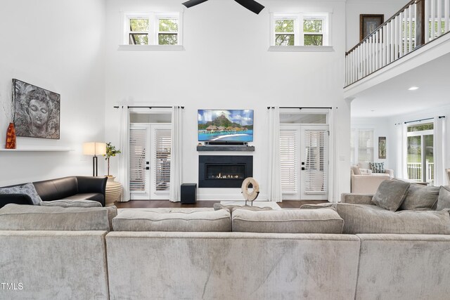 6024 Lunenburg Dr, Raleigh, NC 27603 - living area featuring plenty of natural light, wood finished floors, a towering ceiling, and ceiling fan