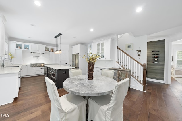 6024 Lunenburg Dr, Raleigh, NC 27603 - dining space featuring dark wood finished floors, baseboards, stairs, and recessed lighting