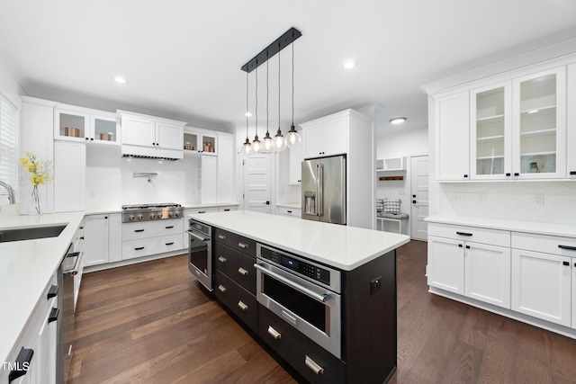6024 Lunenburg Dr, Raleigh, NC 27603 - kitchen featuring a sink, dark cabinetry, stainless steel appliances, light countertops, and white cabinets