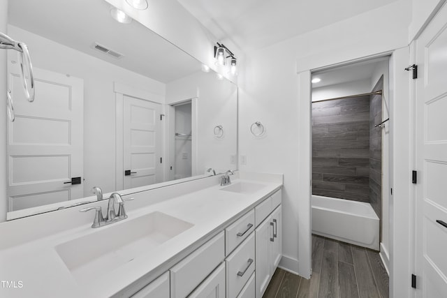 6024 Lunenburg Dr, Raleigh, NC 27603 - bathroom featuring wood finished floors, visible vents, a sink, and double vanity