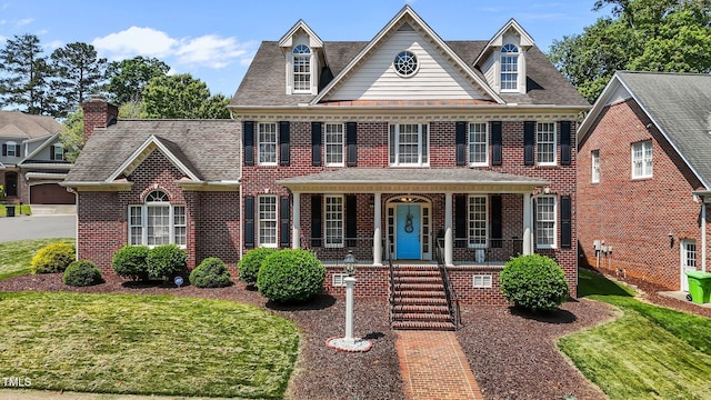 5619 Bennettwood Ct, Raleigh, NC 27612 - colonial inspired home with brick siding, a shingled roof, a front lawn, and covered porch