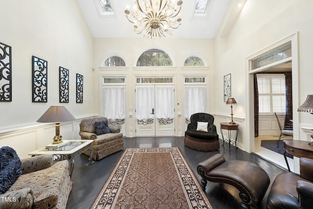 6212 Trevor Ct, Raleigh, NC 27613 - living area with a chandelier, a decorative wall, dark wood-style floors, and a skylight