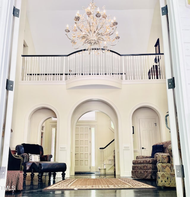6212 Trevor Ct, Raleigh, NC 27613 - foyer entrance with arched walkways, a high ceiling, and stairway