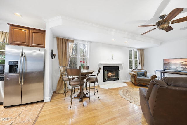 6212 Trevor Ct, Raleigh, NC 27613 - living room with plenty of natural light, light wood-style floors, ornamental molding, and a ceiling fan