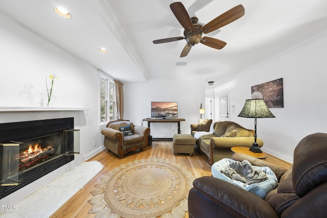 6212 Trevor Ct, Raleigh, NC 27613 - living area featuring a glass covered fireplace, recessed lighting, a ceiling fan, wood finished floors, and crown molding