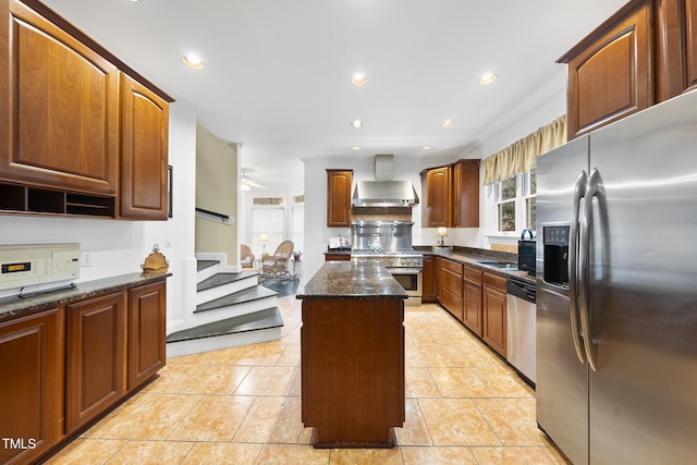 6212 Trevor Ct, Raleigh, NC 27613 - kitchen featuring a sink, wall chimney range hood, appliances with stainless steel finishes, dark stone counters, and a kitchen island