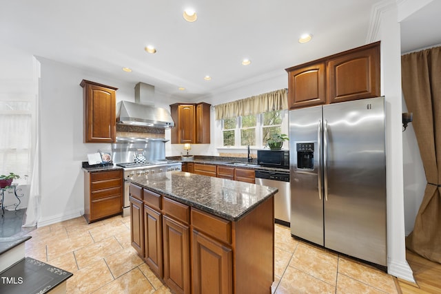 6212 Trevor Ct, Raleigh, NC 27613 - kitchen with recessed lighting, wall chimney range hood, a center island, dark stone counters, and appliances with stainless steel finishes