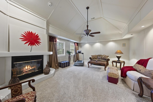 6212 Trevor Ct, Raleigh, NC 27613 - living room featuring a glass covered fireplace, vaulted ceiling, a ceiling fan, a decorative wall, and carpet
