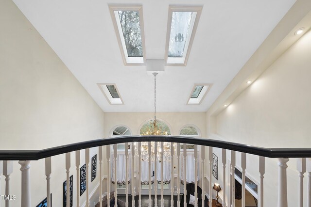 6212 Trevor Ct, Raleigh, NC 27613 - stairs featuring a skylight, high vaulted ceiling, and a chandelier