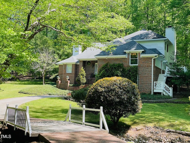 6212 Trevor Ct, Raleigh, NC 27613 - view of front facade featuring a front lawn, brick siding, and a chimney
