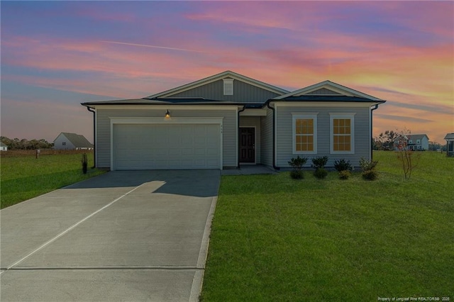 ranch-style house with a front lawn, a garage, and driveway