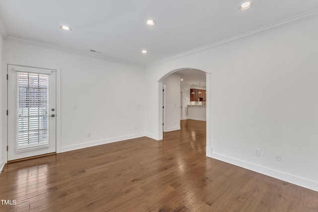 644 Angelica Cir, Cary, NC 27518 - unfurnished room featuring arched walkways, ornamental molding, baseboards, wood finished floors, and recessed lighting
