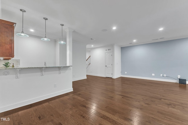 644 Angelica Cir, Cary, NC 27518 - unfurnished living room with recessed lighting, dark wood-style floors, baseboards, stairway, and crown molding