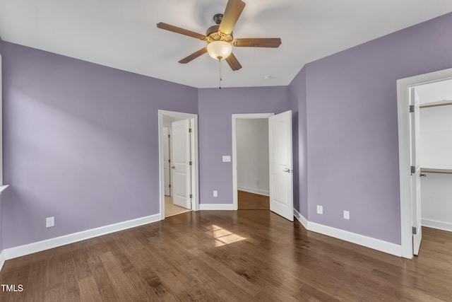 644 Angelica Cir, Cary, NC 27518 - unfurnished bedroom featuring baseboards, wood finished floors, a spacious closet, ceiling fan, and a closet