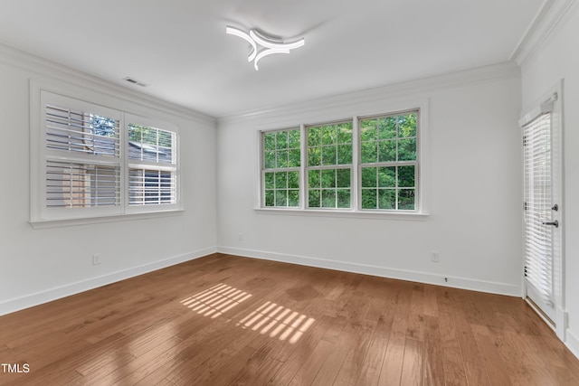 644 Angelica Cir, Cary, NC 27518 - unfurnished bedroom featuring ornamental molding, multiple windows, hardwood / wood-style flooring, and baseboards