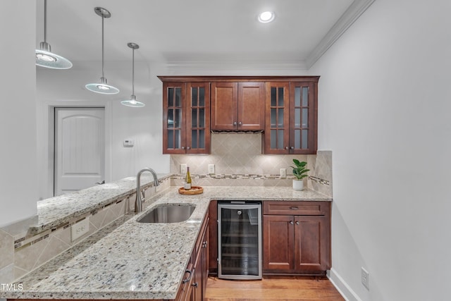 644 Angelica Cir, Cary, NC 27518 - kitchen featuring beverage cooler, a sink, backsplash, decorative light fixtures, and light stone countertops