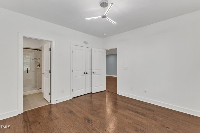 644 Angelica Cir, Cary, NC 27518 - unfurnished bedroom featuring wood finished floors, baseboards, a closet, and ensuite bathroom