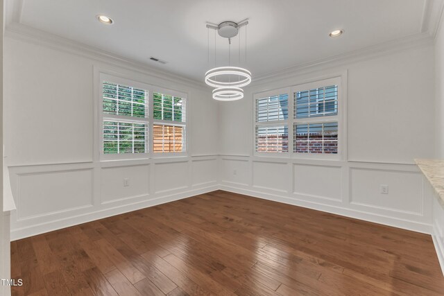 644 Angelica Cir, Cary, NC 27518 - unfurnished dining area featuring a chandelier, ornamental molding, a decorative wall, a wainscoted wall, and recessed lighting